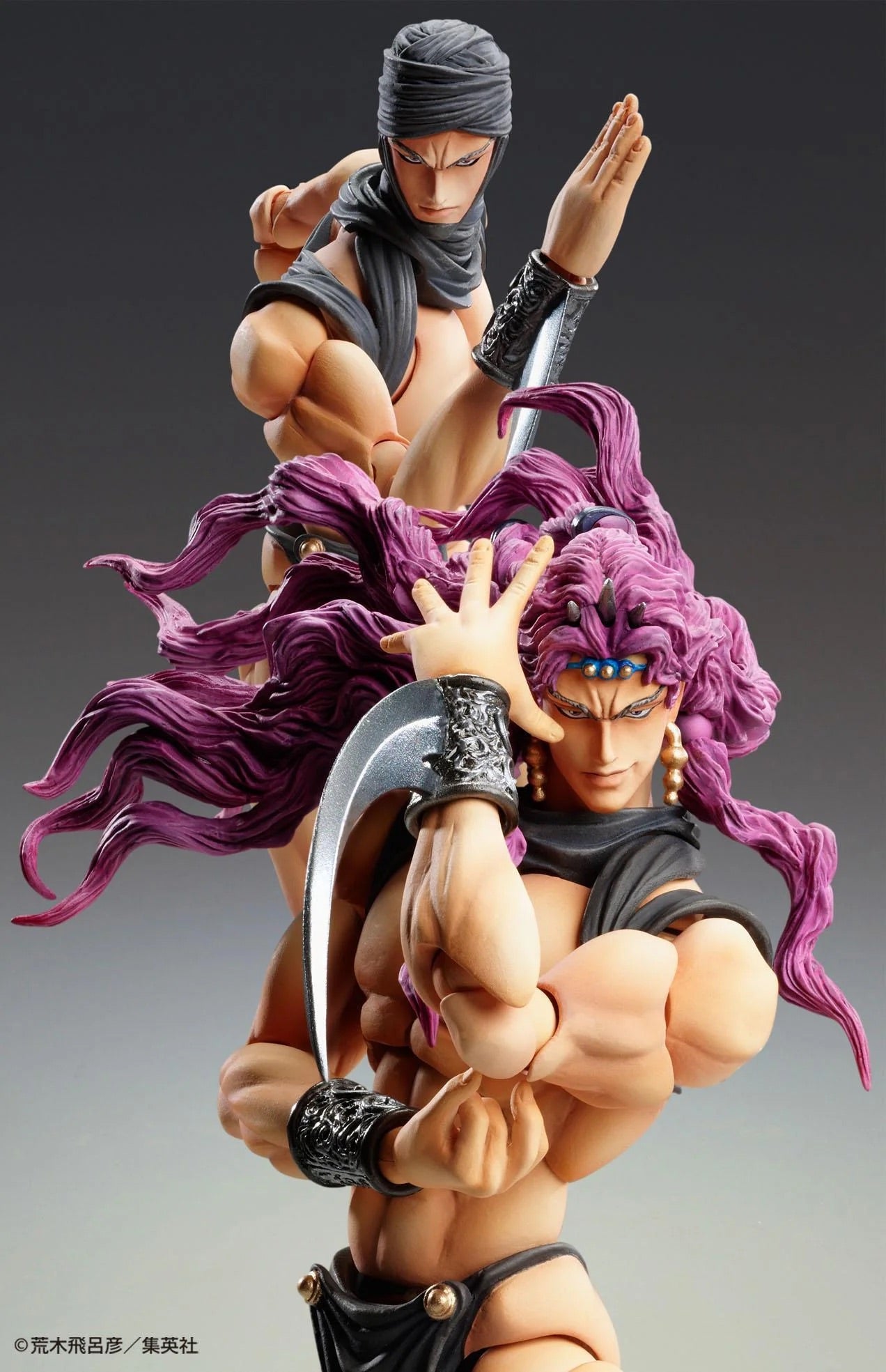 A composite shot of the Kars figure, featuring the swappable head wearing a turban, interacting with the purple-haired, non-turbaned head in a dynamic pose.