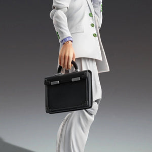 Yoshikage Kira figure posed holding the briefcase accessory and answering a small, vintage mobile phone.