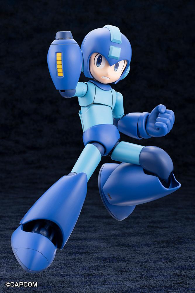 Action pose of Mega Man charging his Mega Buster displaying the yellow power gauge with teeth-clenched face plate.