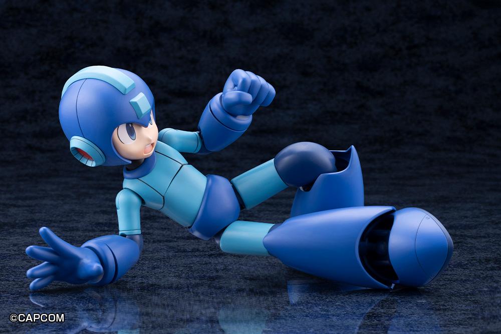Kotobukiya Mega Man 11 Grande Scale model kit posed in a ground slide maneuver with an open shouting face plate.