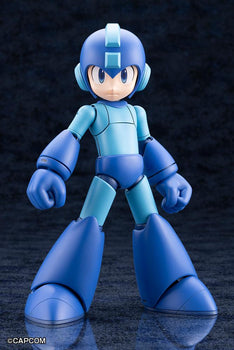 Front standing view of the assembled Kotobukiya Mega Man 11 Grande Scale model kit with neutral expression on a dark reflective surface.