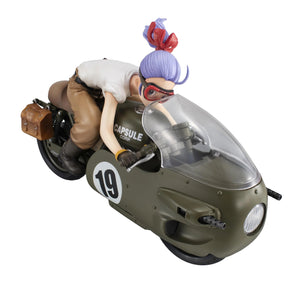 A high-angle, frontal view of the Bulma figure crouching low on her Capsule Corp. motorcycle while wearing racing goggles.