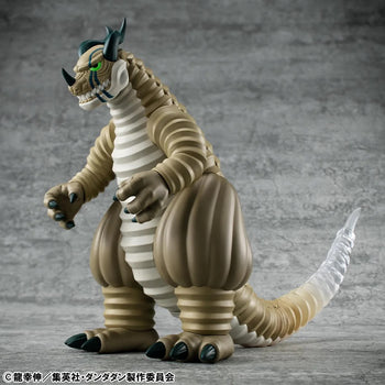 Angled front view of the Megahouse DAN DA DAN Transparent Kaiju Sofubi Figure, showcasing its large size and powerful stance.