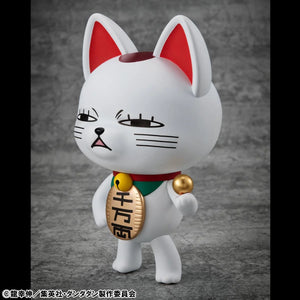 A three-quarter view of the Turbo Granny Fortune Cat figure, highlighting its white body, red-lined ears, and large gold "luck" coin accessory.