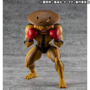 Front view of the MegaHouse Dandadan Occultic Sofubi Collection Dover Demon Vinyl Figure, featuring its signature yellow body, saucer-shaped head, and red boxing gloves.