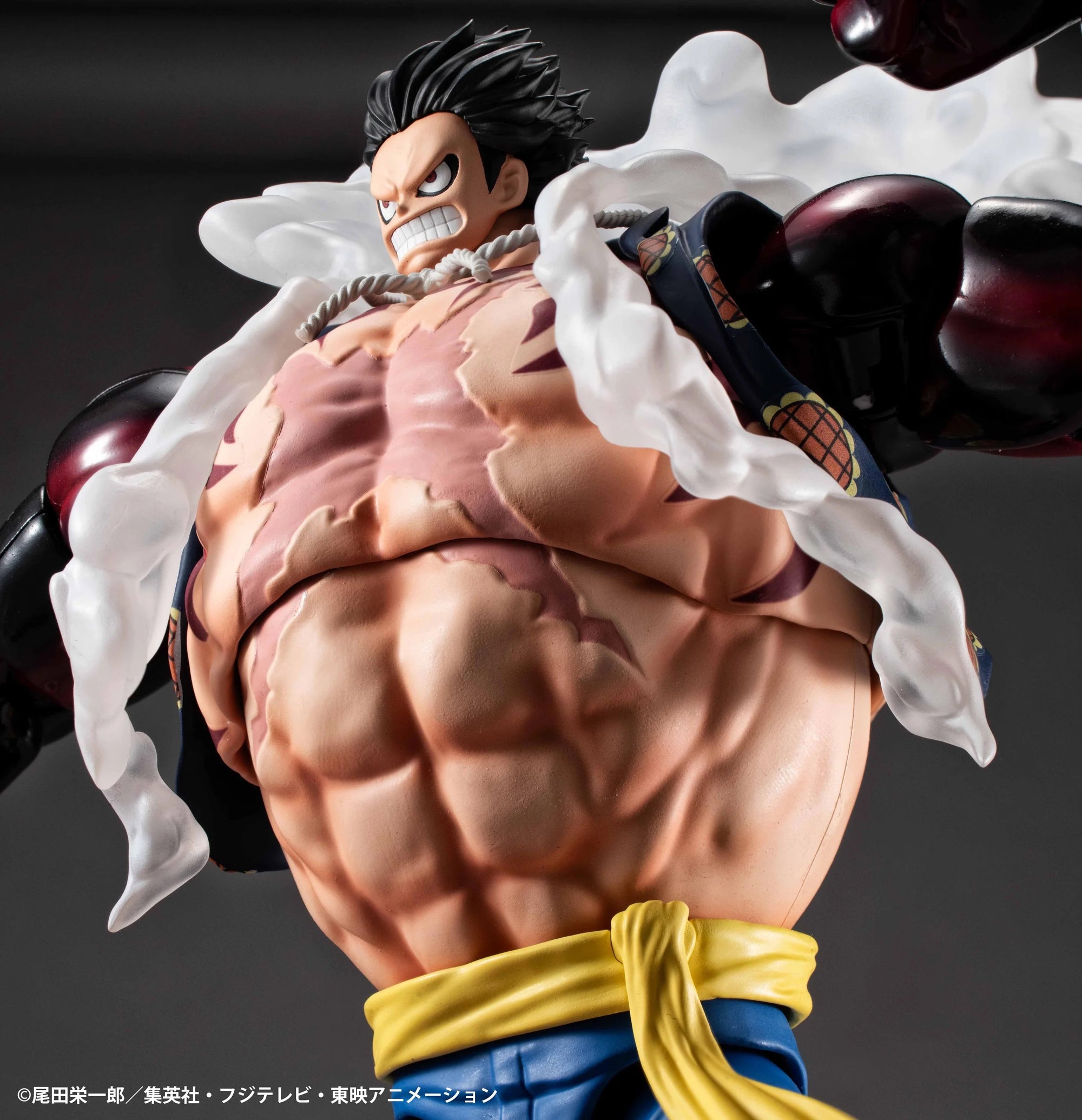 An extreme close-up of the Luffy Gear 4 Boundman figure's inflated torso, focusing on the highly detailed abdominal muscles and scar.