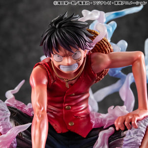 A straight-on close-up of the Luffy Gear 2 figure's face while crouched, showing his full concentration and veins.