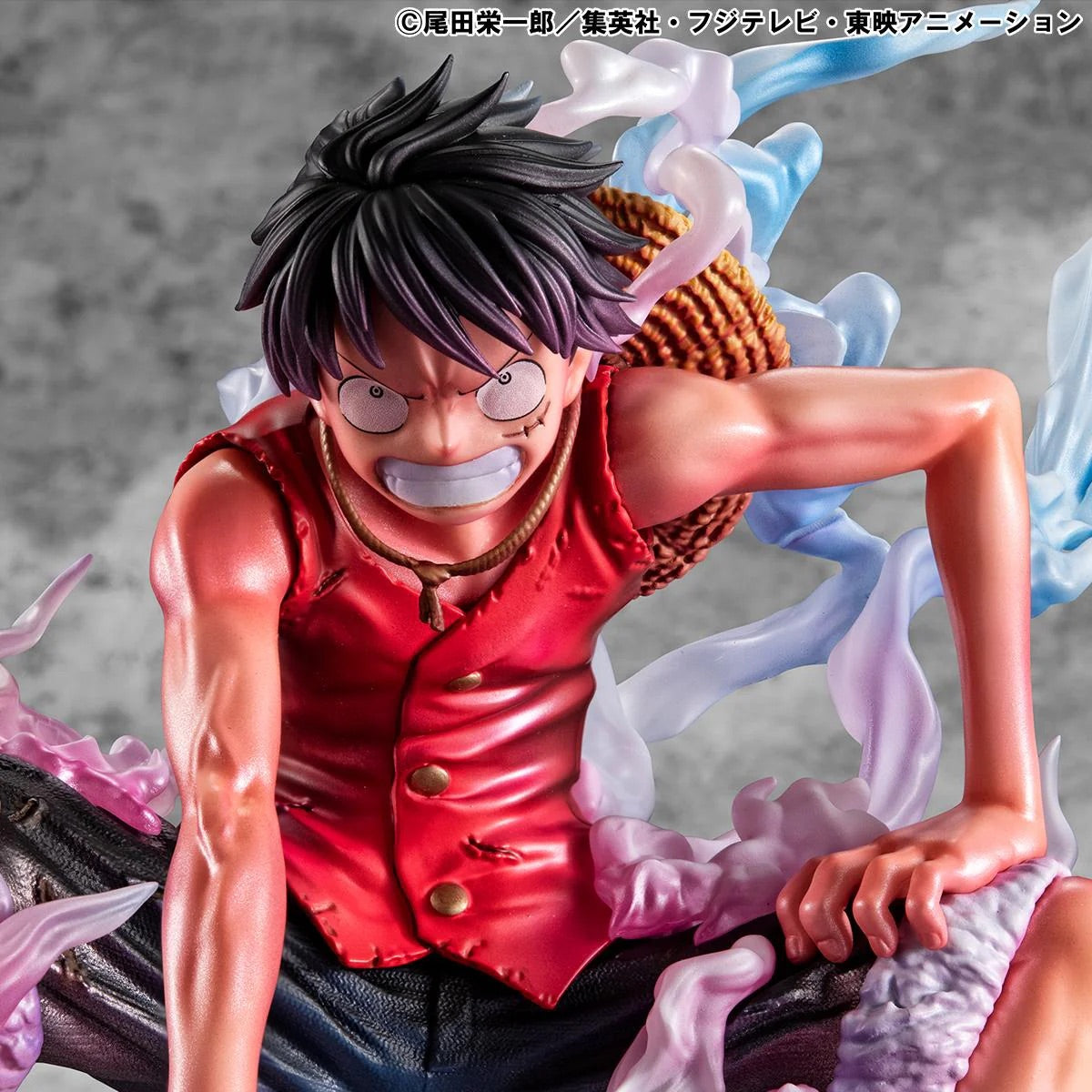 A bright close-up of Luffy's face and chest, showing the contrast between his tanned skin and the red vest.