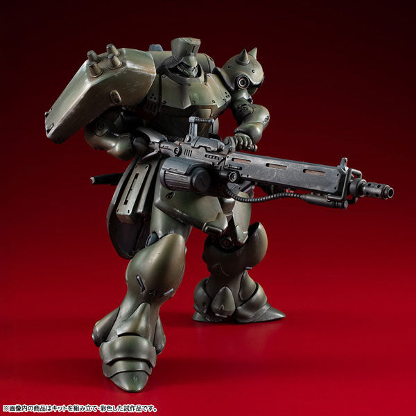 Front three-quarter standing view of the painted Mobile Suit Gundam VAKIT Geara Doga Commander Type plastic model kit holding its signature heavy rifle.