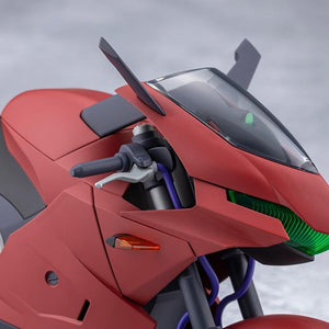 Close-up of the red sports bike front cowl featuring green clear visor headlight and handlebars.