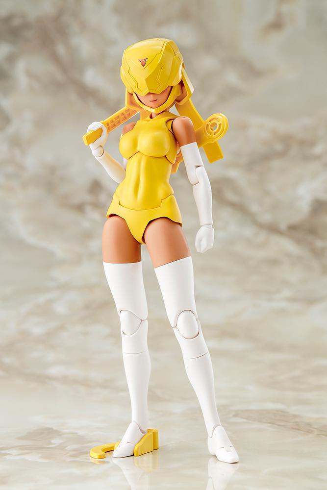 Front view of the Megami Device B1R-L Chassis Kit model kit with helmet visor down, holding yellow runner accessory over shoulder.