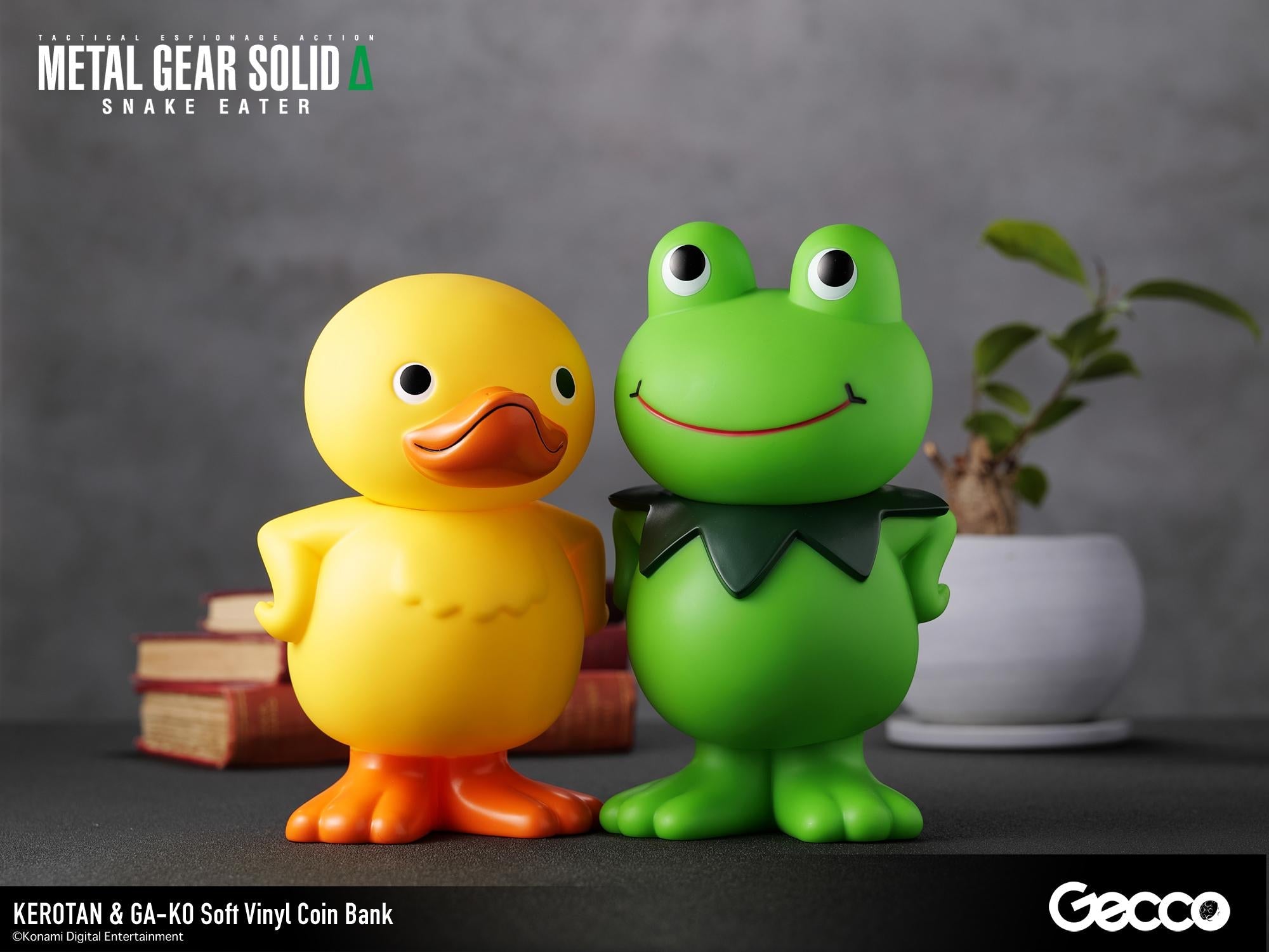 Close-up shot of the GA-KO duck and Kerotan frog vinyl coin banks posing side-by-side on a desk.