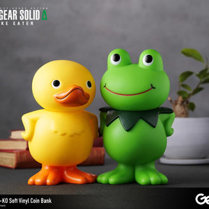 Close-up shot of the GA-KO duck and Kerotan frog vinyl coin banks posing side-by-side on a desk.