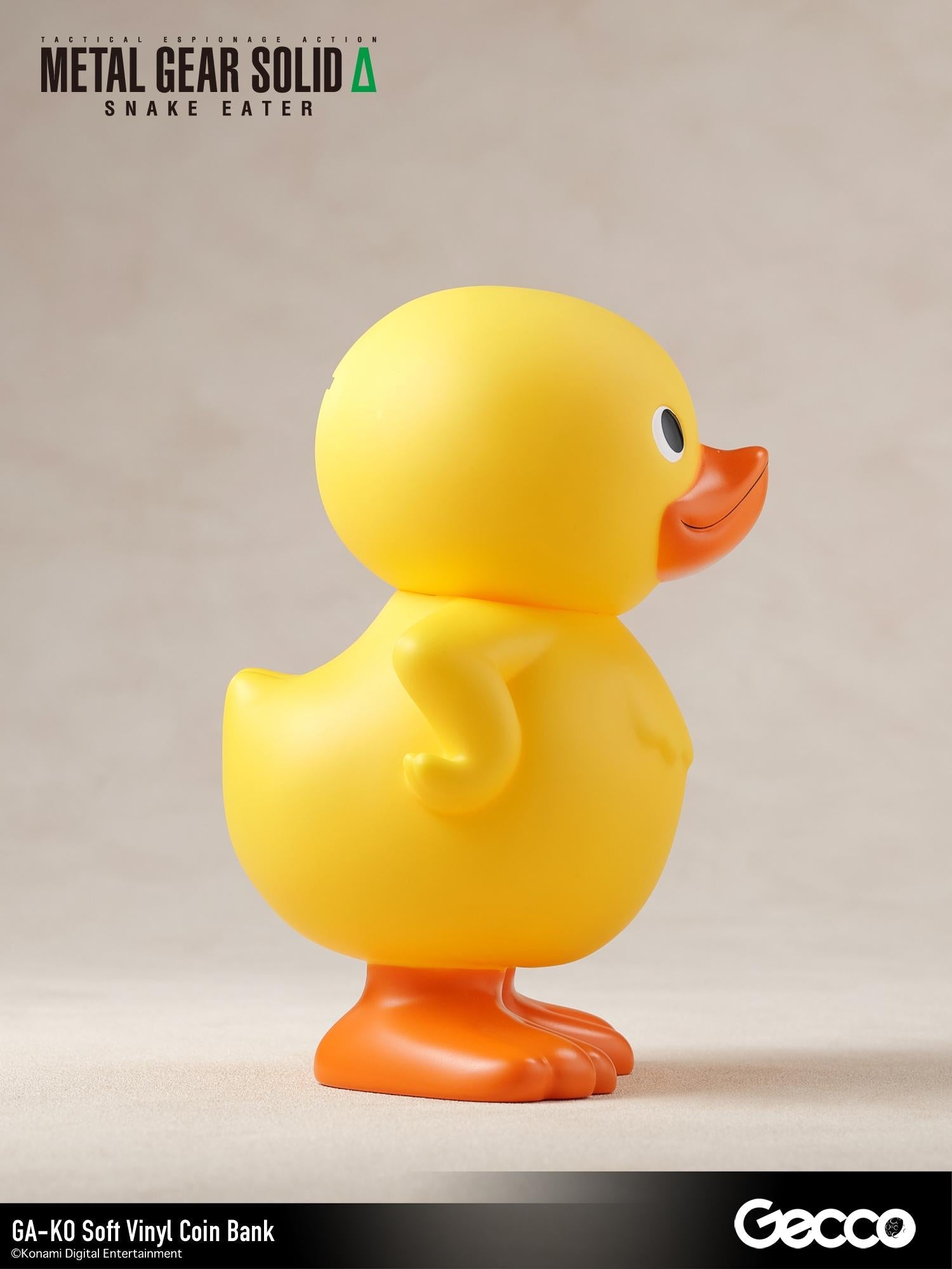 Right side profile view of the GA-KO yellow duck soft vinyl coin bank.