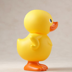 Right side profile view of the GA-KO yellow duck soft vinyl coin bank.