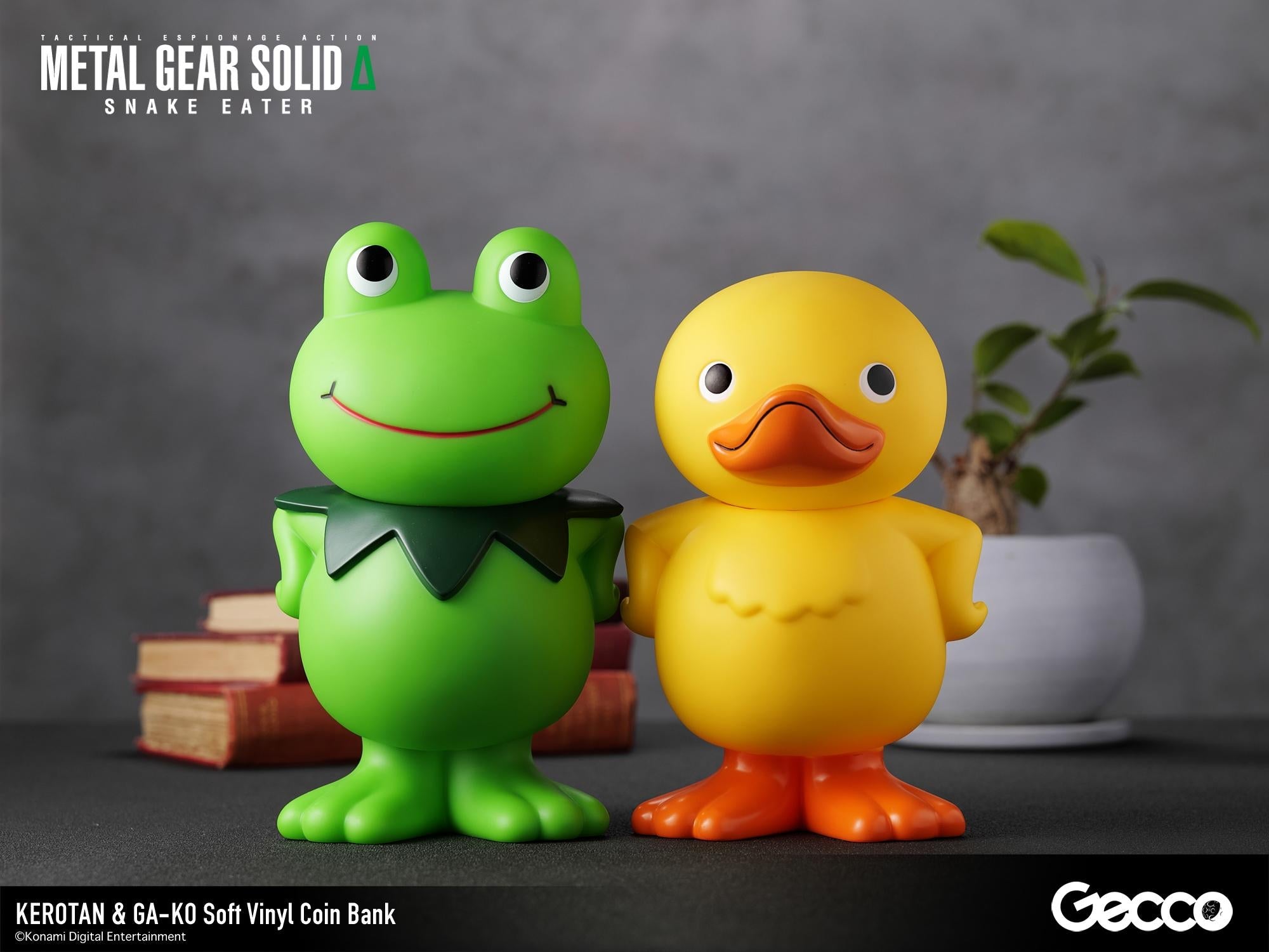 Kerotan green frog and GA-KO yellow duck soft vinyl coin banks displayed together on a decorated desk surface.