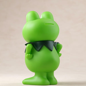 Rear three-quarter view showing the coin slot on the head of the Kerotan soft vinyl coin bank.