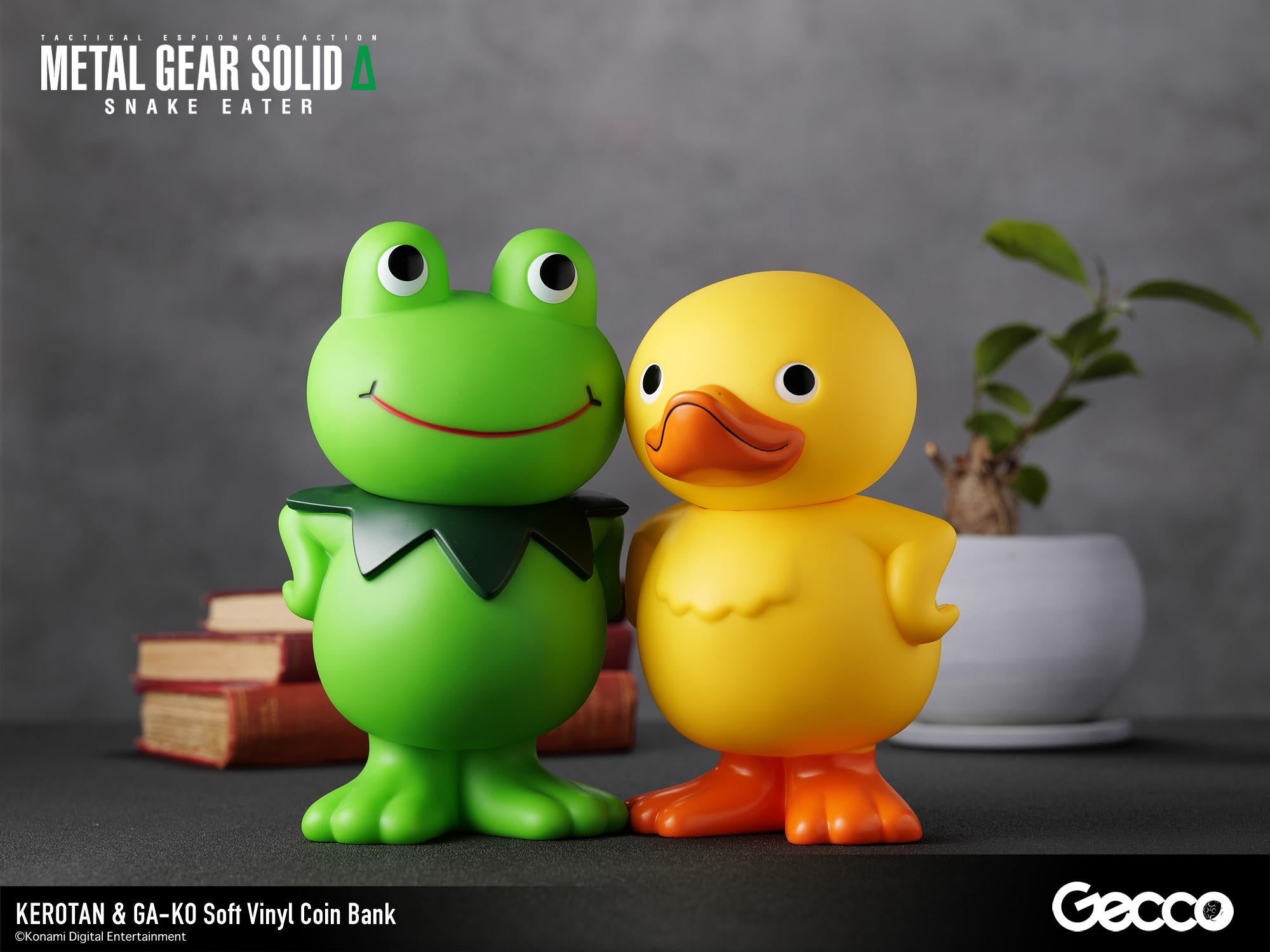 Close-up shot of the Kerotan frog and GA-KO duck vinyl coin banks posing side-by-side on a desk.