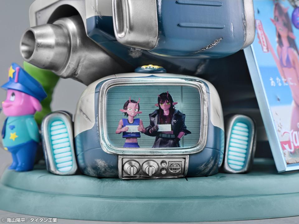 Close-up shot of the secondary television screen built into the base showing two pink alien characters.