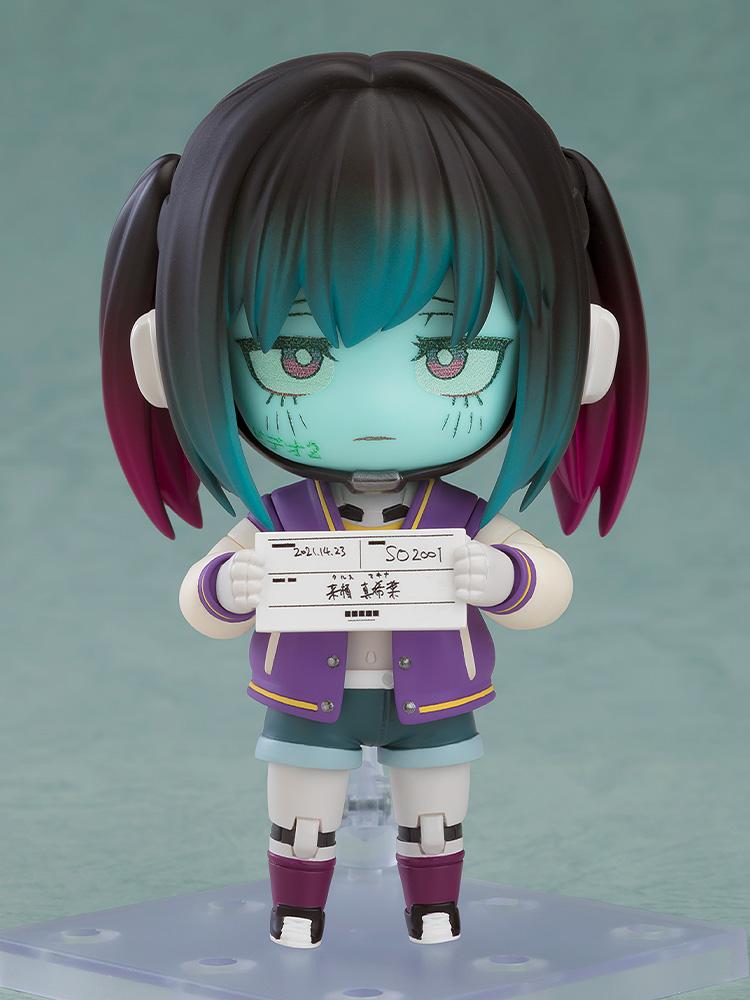 Makina Nendoroid figure with a glaring face plate, blue-toned skin, and dark pigtails wearing a purple varsity jacket.