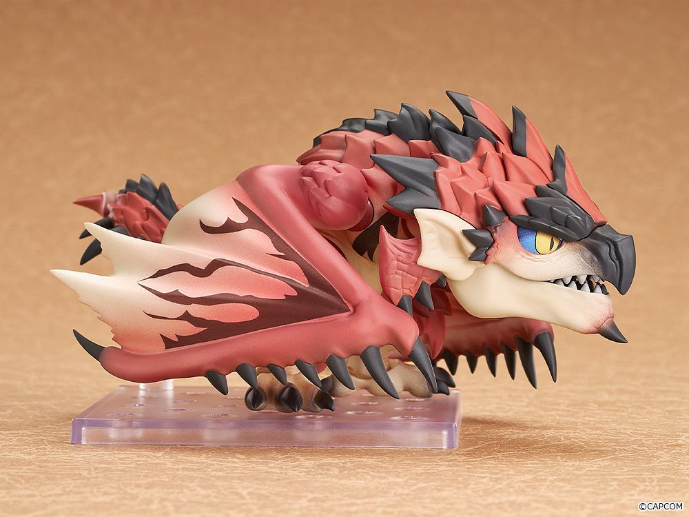 Side view of the Rathalos Nendoroid figure in a low crouching position with folded wings resting on a display base.