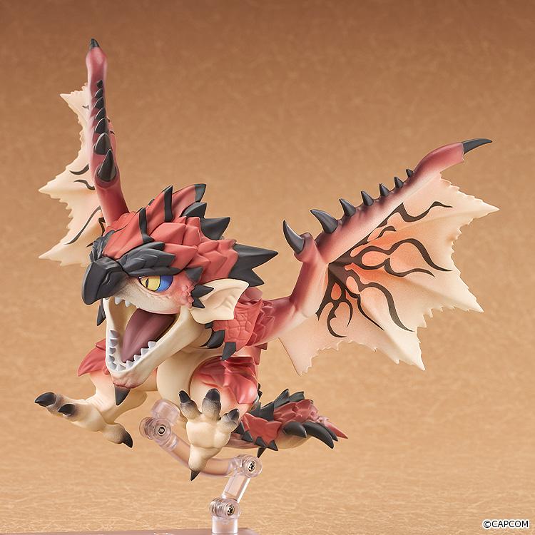 Dynamic airborne pose of the Rathalos Nendoroid figure held aloft by a clear support stand with claws extended.