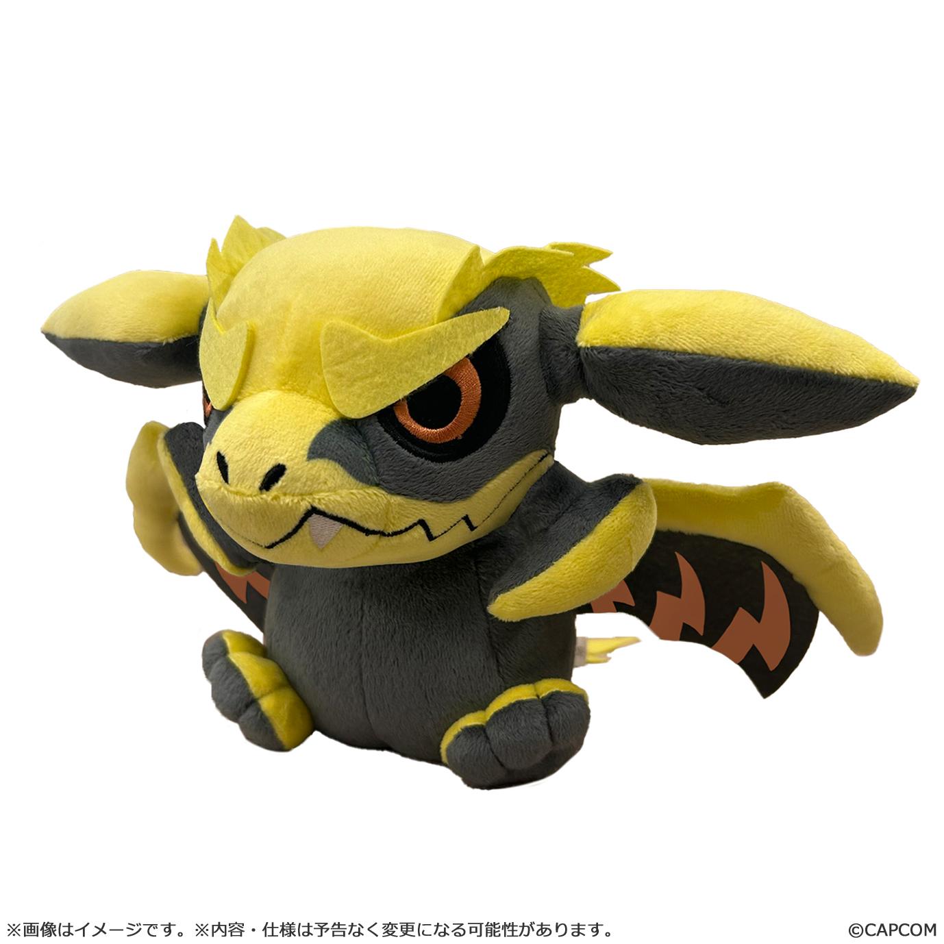 Chibi-style Rey Dau plush toy from Monster Hunter Wilds, featuring yellow and dark gray soft fabric with orange eyes.
