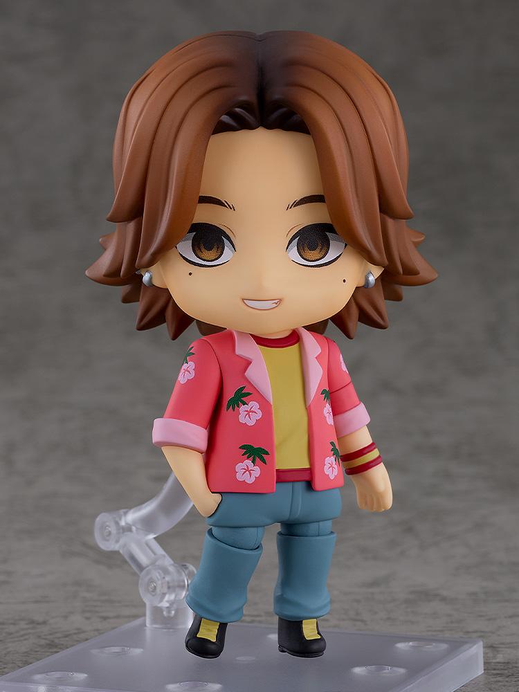 Mouthwashing Daisuke Nendoroid figure with smiling face plate and floral Hawaiian shirt on a clear stand.