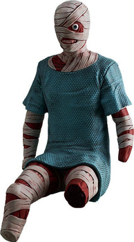 Isolated studio cutout of the Mouthwashing POP UP PARADE Swacchao! Curly figure sitting, featuring head bandages, a single exposed eye, and a blue hospital gown.