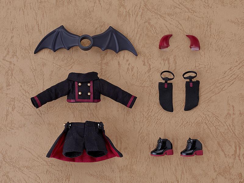 Flat lay of the included accessories for the Devil: Berg Nendoroid Doll, showing the removable bat wings, red devil horns, top, layered shorts, black socks, and magnetic short boots.