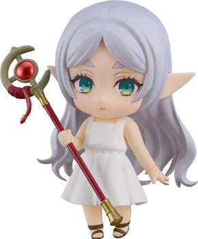 Full-body studio shot of Nendoroid Frieren in her Apprentice Era white dress, holding her magical staff against a white background.