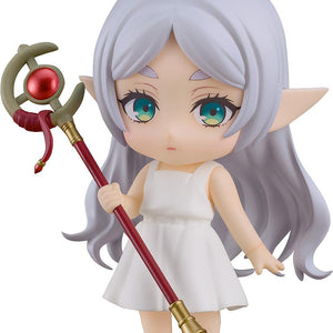Full-body studio shot of Nendoroid Frieren in her Apprentice Era white dress, holding her magical staff against a white background.