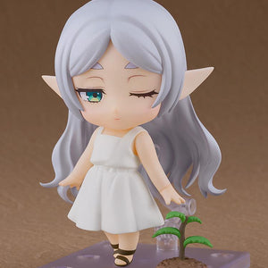 Posed shot of Frieren Nendoroid looking down at a small seedling accessory, featuring the one-eye-closed face plate.