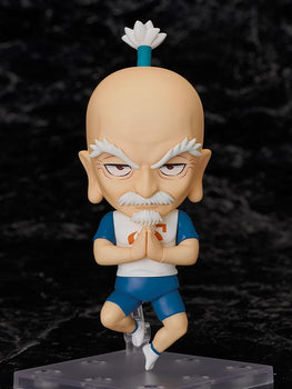 The Nendoroid Netero figure suspended on its stand in a mid-air praying pose against a dark marble background.