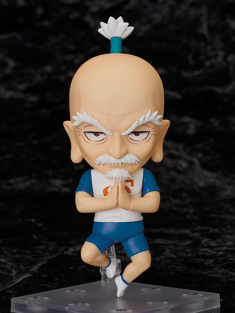 The Nendoroid Netero figure suspended on its stand in a mid-air praying pose against a dark marble background.