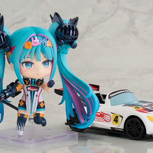 A back and side view of the Nendoroid Racing Miku: 2026 Ver. figure, displaying the detailed outfit design from the rear and the large articulated twin-tails.