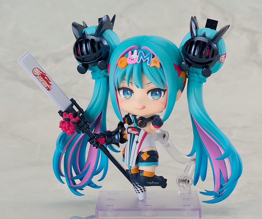 Hatsune Miku GT Project Nendoroid Racing Miku: 2026 Ver. figure in a playful full body pose, showing the face plate with a tongue sticking out and holding the speaker rod.