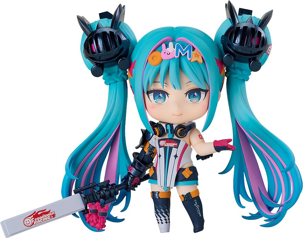 A full body view of the Hatsune Miku GT Project Nendoroid Racing Miku: 2026 Ver. figure, smiling, holding her speaker rod accessory next to the included Nendoroid car.