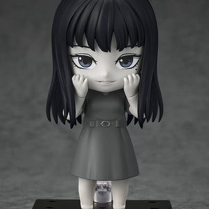 Studio shot of Tomie Nendoroid figure with hands to cheeks and a subtle smiling expression.
