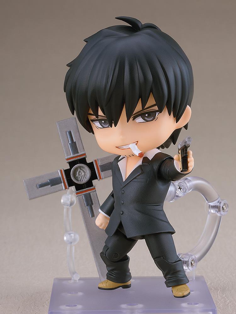 Full standing view of the Nicholas D. Wolfwood Nendoroid figure on a display stand aiming a handgun while holding the Punisher cross with a cigarette face plate.