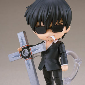 Nicholas D. Wolfwood Nendoroid figure wearing black sunglasses and resting his hand on the upright Punisher cross with a cigarette in mouth.