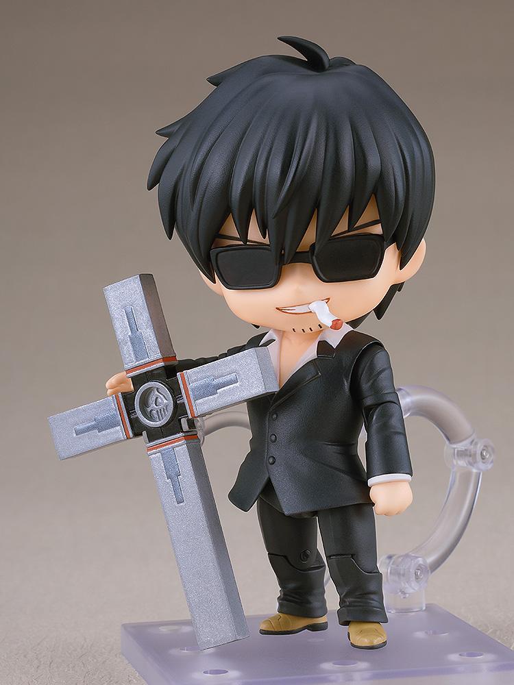 Nicholas D. Wolfwood Nendoroid figure wearing black sunglasses and resting his hand on the upright Punisher cross with a cigarette in mouth.