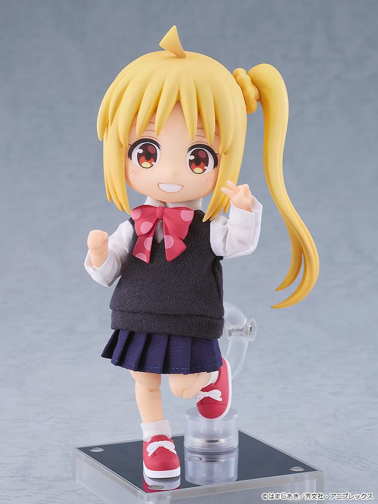 Cheerful Nijika Ijichi Nendoroid Doll action figure standing on a clear magnetic display base while holding up a peace sign in a grey studio setting.