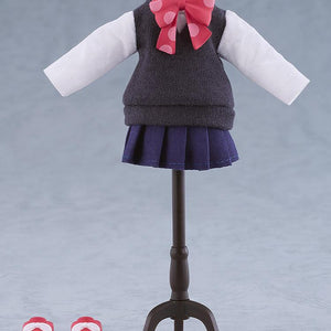 The fabric school uniform top, navy pleated skirt, pink polka-dot bow, and red magnetic saddle shoes of the Nendoroid Doll displayed on a miniature clothing mannequin stand.