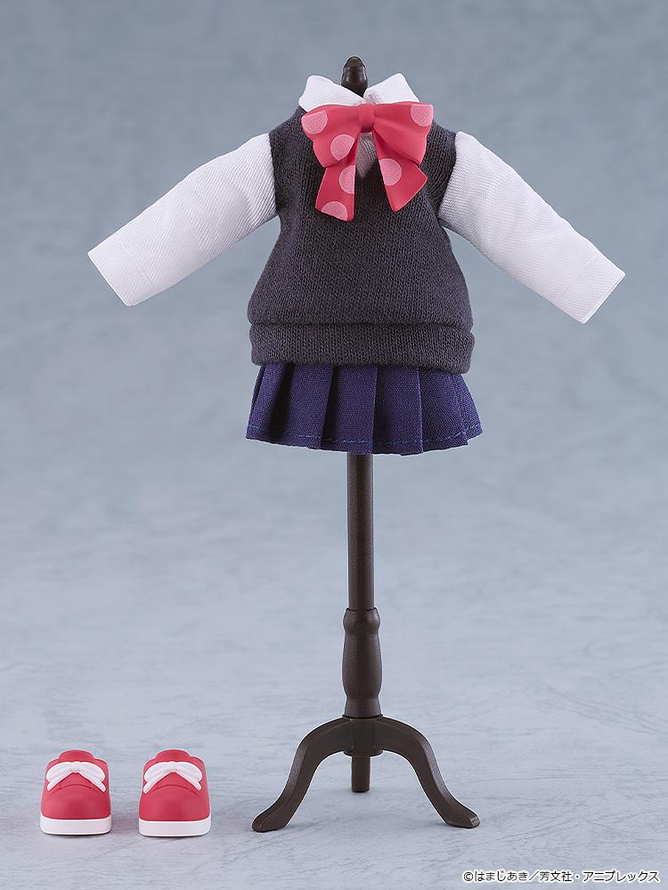 The fabric school uniform top, navy pleated skirt, pink polka-dot bow, and red magnetic saddle shoes of the Nendoroid Doll displayed on a miniature clothing mannequin stand.
