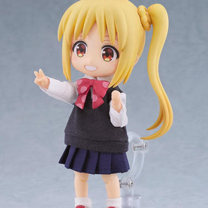 Three-quarter view of the Nijika Ijichi Nendoroid Doll figure mounted on its magnetic stand, showcasing the detailed fabric school uniform vest, pleated skirt, and pink polka-dot bow.