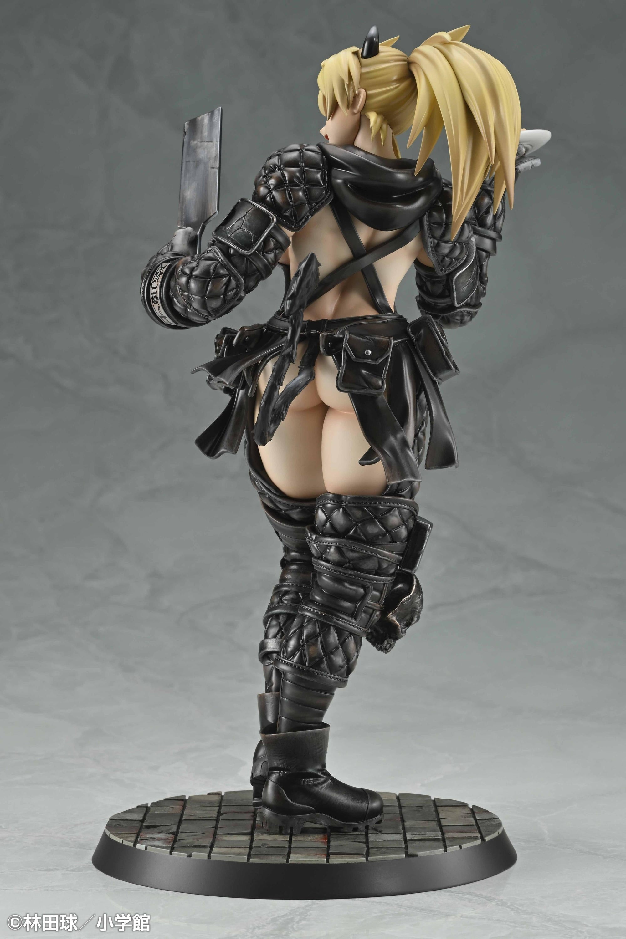 Direct back view of the Nikaido 1/7 scale statue showing the open-back armor design, detailed hair sculpt, and tactical pouches.