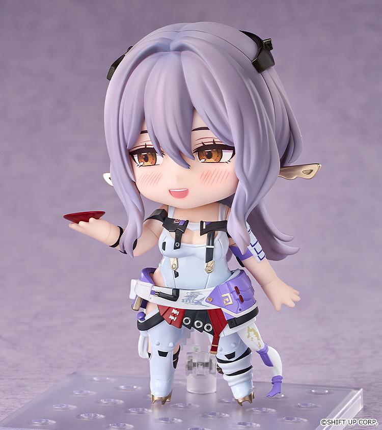 Scarlet Nendoroid figure from Goddess of Victory: Nikke shown without her hat, featuring a cute blushing face plate while holding a small red Sakazuki sake cup.