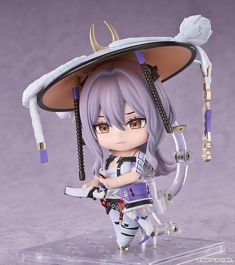 Side-angled view of the Nikke Scarlet Nendoroid action figure showcasing a serious face plate and her hand resting near her sheathed katana hilt.