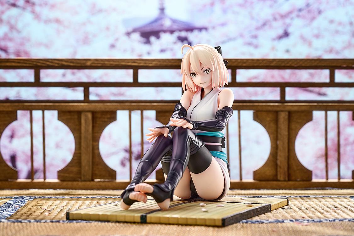 Saber Okita Souji scale figure displayed against a scenic cherry blossom and traditional Japanese temple backdrop.